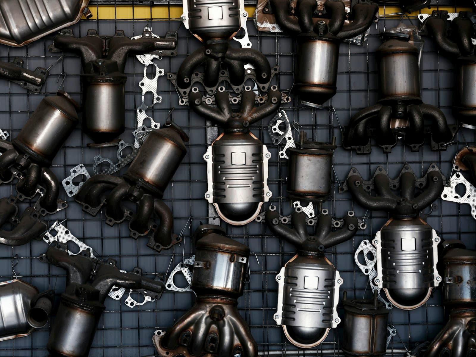 Collection of car exhaust catalytic converters and industrial parts